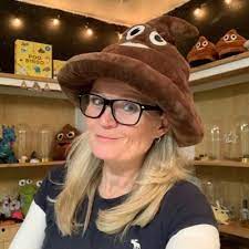 Susie Maguire, of the Poop Museum, wearing a poop emoji hat