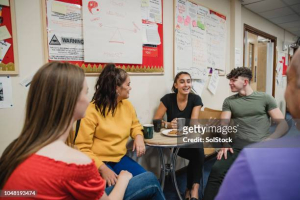 Teens gathering at a table and chatting